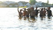 Perjuangan Warga Memburu Hadiah Panjat Pinang di Pinggir Sungai Musi Palembang