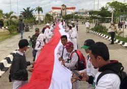 Ansor Bentangkan Merah Putih 1.500 Meter di Perbatasan RI-Papua Nugini