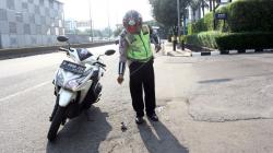 Aksi Polantas Polda Metro Jaya Sisir Jalan Gatot Subroto Cari Paku Berserakan