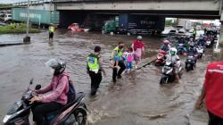 Polisi Berjibaku Bantu Warga Melintasi Banjir di Semarang<