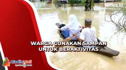 Warga Gunakan Sampan untuk Beraktivitas akibat Banjir di Langkat