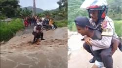Menegangkan, Aksi Warga Gendong Polisi Seberangi Arus Deras di Sikka
