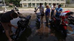 Bule Ini Bersosialisasi dengan Cara Cuci Motor Warga Surabaya