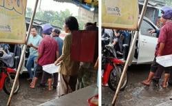 Viral Seorang Ibu Gendong Bayi Dipaksa Turun dari Taksi Online saat Hujan Deras