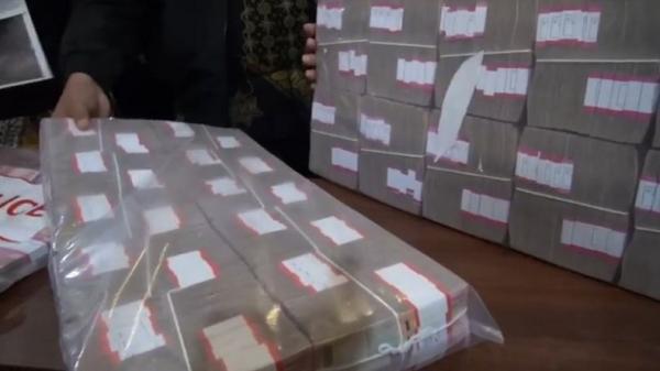Polda Jatim membeberkan barang bukti uang Rp2,6 miliar yang disita dari pelaku pembobolan kartu kredit di Mapolda Jatim, Surabaya, Jumat (6/12/2019). (Foto: iNews/Rahmat Ilyasan)