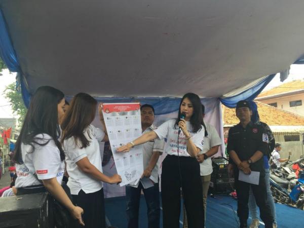 Ketua Kartini Perindo yang juga caleg DPR RI Dapil Jakarta II nomor urut 01 Liliana Tanaja Tanoesoedibjo melakukan sosialisasi pencoblosan sebelum acara bazar sembako murah di Tanah Tinggi, Johar Baru, Jakarta Pusat, Senin (8/4/2019). (Foto: iNews.id/Wildan Catra Mulia)