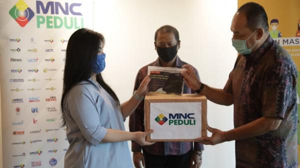 Ketua MNC Peduli Syafril Nasution (kanan) menyerahkan bantuan masker kain kepada Blue Bird, Jumat (12/6/2020). (Foto: MNC Media).