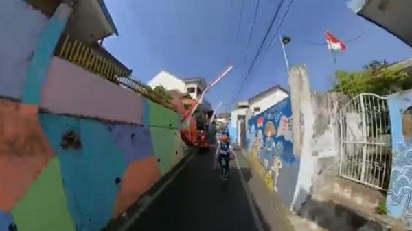 sepeda Pesepeda melewati kampung warna-warni Jodipan, Malang.