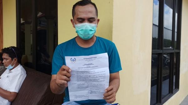 Seorang karyawan korban PHK menunjukkan SK PHK, Rabu (9/9/2020). (Foto: iNews/Haryanto)