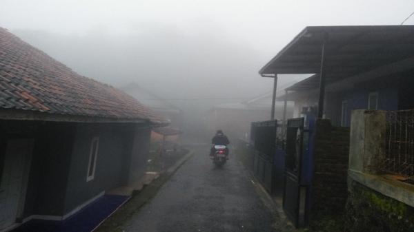 Pengendara motor menembus kabut tebal yang menyelimuti Dusun Jotang, Desa Jagamulya, Kecamatan Malausma, Kabupaten Majalengka. (Foto: Inin Nastain)