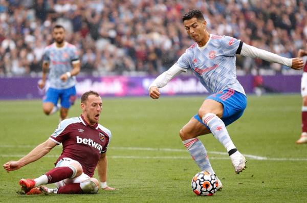Cristiano Ronaldo vs Vladimir Coufal Striker Manchester United, Cristiano Ronaldo (kanan) mengecoh pemain West Ham United, Vladimir Coufal dalam laga lanjutan Liga Inggris 2021/2022 di Stadion London, Minggu (19/9/2021). (Foto: REUTERS/John Sibley)