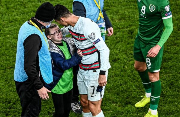 Cristiano Ronaldo menunjukkan keramahannya kepada para fansnya di laga Kualifikasi Piala Dunia 2022 Zona Eropa. Dia memberikan jersey ke fansnya. (foto: Twitter/BRfootball).