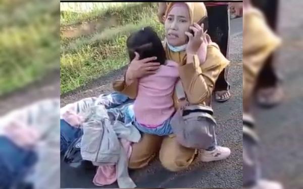 Fakta begal1 Sulistiani merangkul anaknya yang menangis melihat ayahnya terkapar di aspal karena ditembak begal. (Foto: Ist)