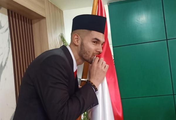 Sandy Walsh Pesepak bola Sandy Walsh mencium bendera merah putih usai melaksanakan sumpah menjadi WNI di Kanwil Kemenkumham, Jakarta, Kamis (17/11/2022). (Foto: MPI/Ilham Sigit)