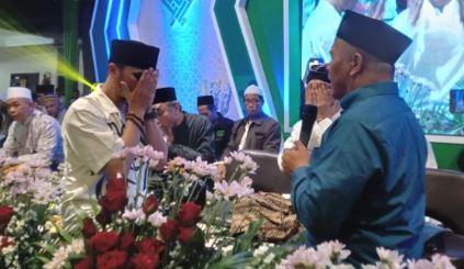 Ustaz Hanan Attaki mengusap mukanya setelah mengucapkan baiat atau ikrar menjadi warga NU di hadapan Ketua PWNU Jatim KH Marzuki Mustamar. (Foto: ist/Instagram Dawuh Guru)