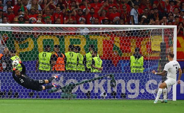 Kiper Timnas Portugal Diogo Costa memblok tendangan penalti Jure Balkovec pada 16 besar Euro 2024 di Waldstadion, Frankfurt, Jerman, Selasa (2/7/2024) dini hari WIB. Portugal menang 3-0. (Foto: REUTERS)