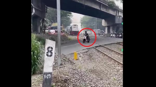 Pengendara sepeda motor nyaris tertabrak kereta api di pelintasan sebidang Cimindi, perbatasan Kota Bandung&ndash;Cimahi, Jawa Barat. (Foto: Rekaman video warga).