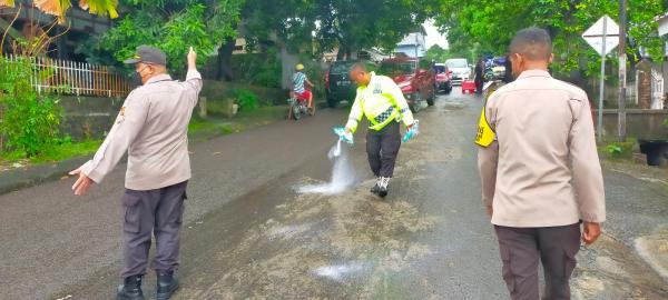 Personel Polsek Soreang Bergerak Cepat Bersihkan Tumpahan Oli yang Bahayakan Pengguna Jalan