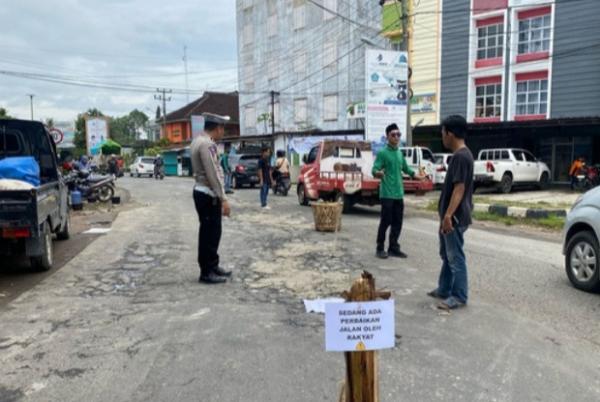 Polres Pringsewu Kawal Aksi Pemuda Tambal Jalan Rusak untuk Cegah Kecelakaan