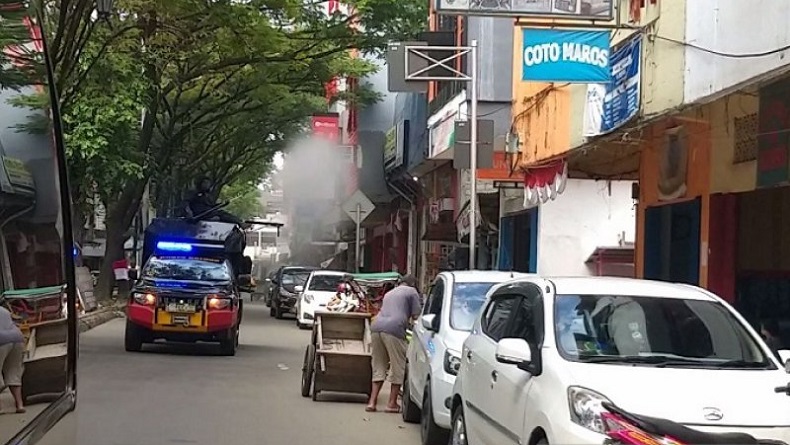 Personel Brimob Polda Maluku Semprot Pusat Perbelanjaan dengan Disinfektan
