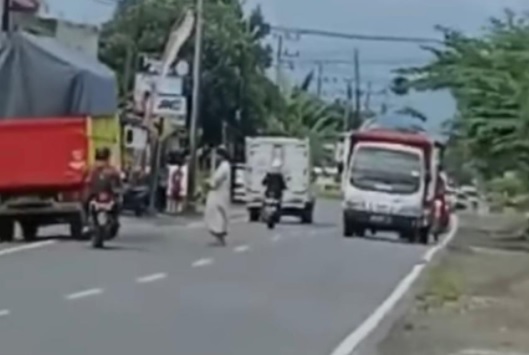 Viral Pria Misterius Berserban Hitam Salat di Tengah Jalan Raya, Netizen Geram