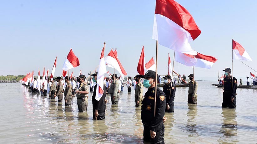 Marinir dan Masyarakat Pesisir Surabaya Berendam di Laut Ikuti Upacara HUT RI - Bagian 4